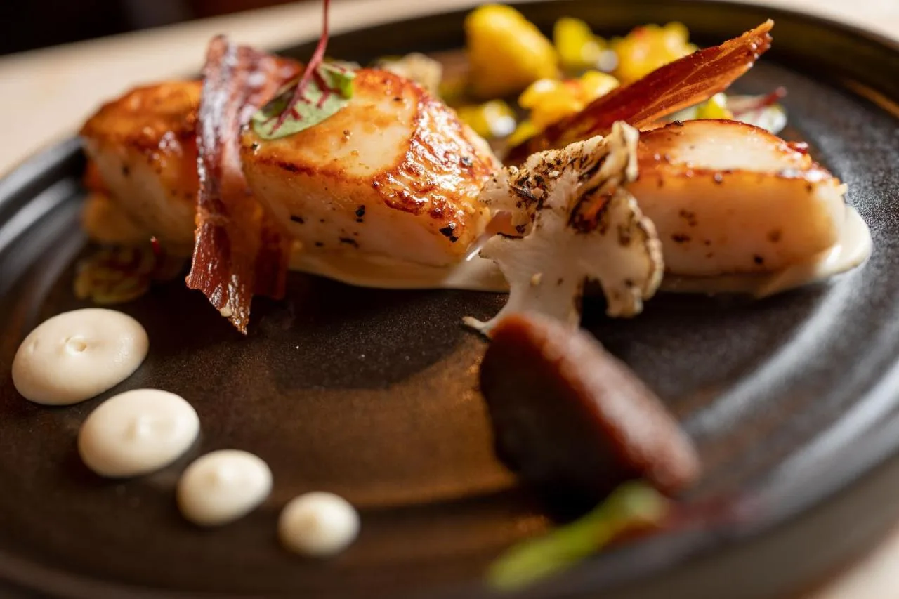 a plate of food with meat and vegetables on it at No11 Boutique Hotel & Brasserie in Edinburgh
