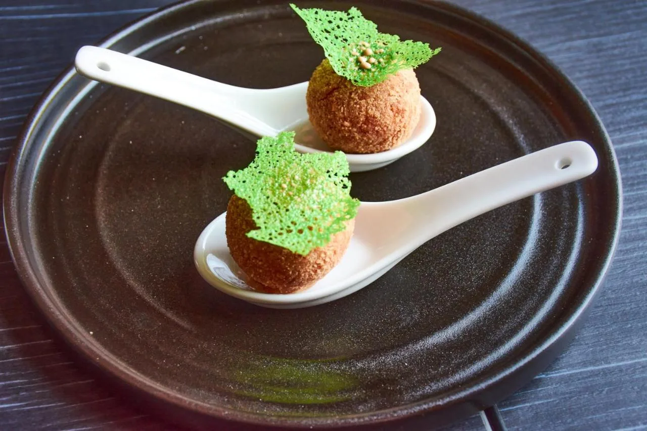 two desserts on a plate with a spoon and a fork at No11 Boutique Hotel & Brasserie in Edinburgh